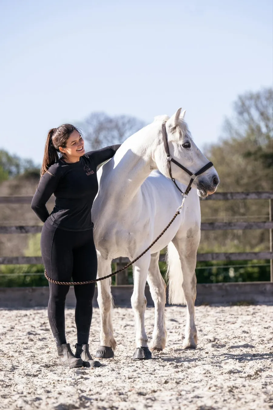 Elena with a white horse during an equine physiotherapy session